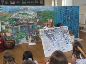 Female teacher showing a class of children a map of Ancient Greece
